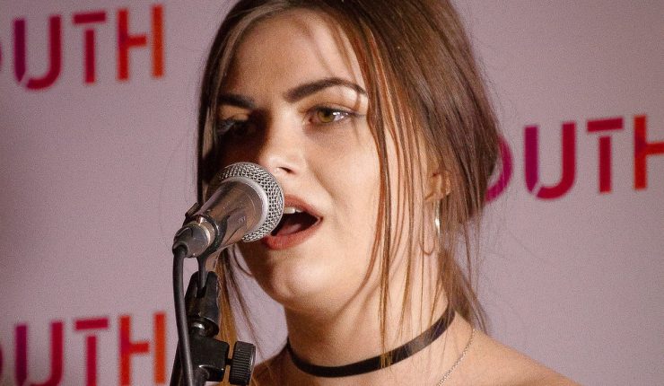 Photo of a girl singing at UK Youth's Gala Dinner 2017