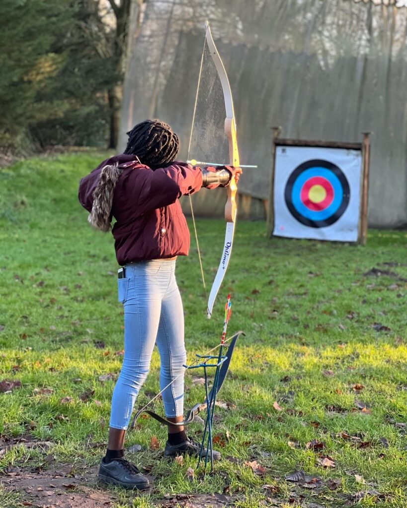 A young person enjoys archery as part of the EmpowHER programme.