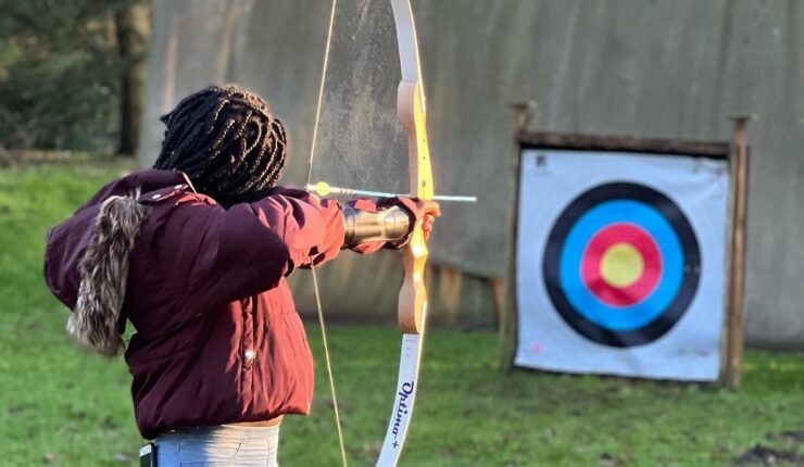 A young person enjoys archery as part of the EmpowHER programme.
