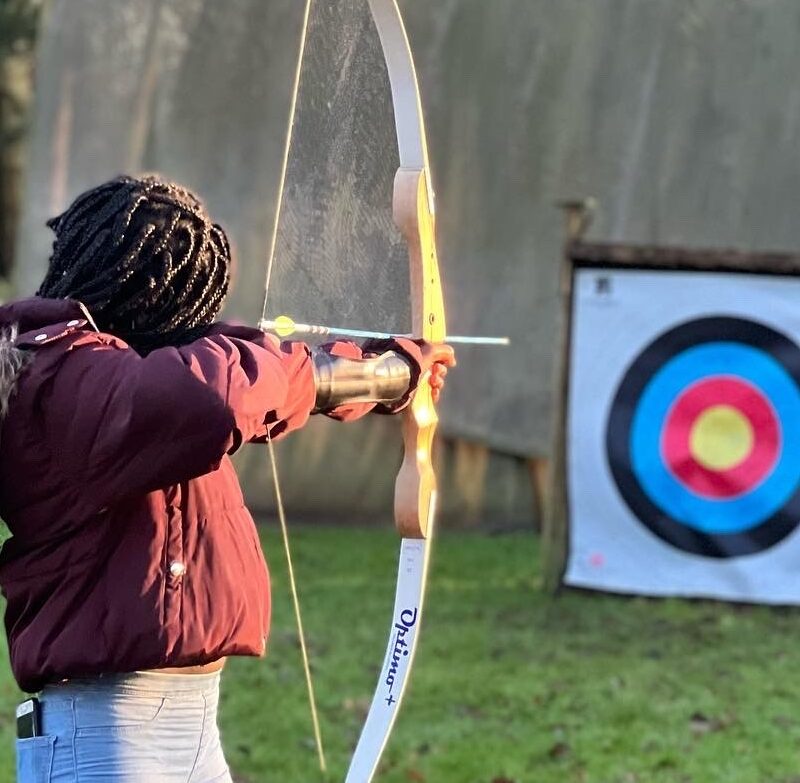 A young person enjoys archery as part of the EmpowHER programme.