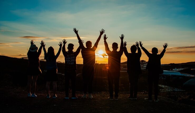 A group of young people in silhouette raise their arms. Picture: Pixabay