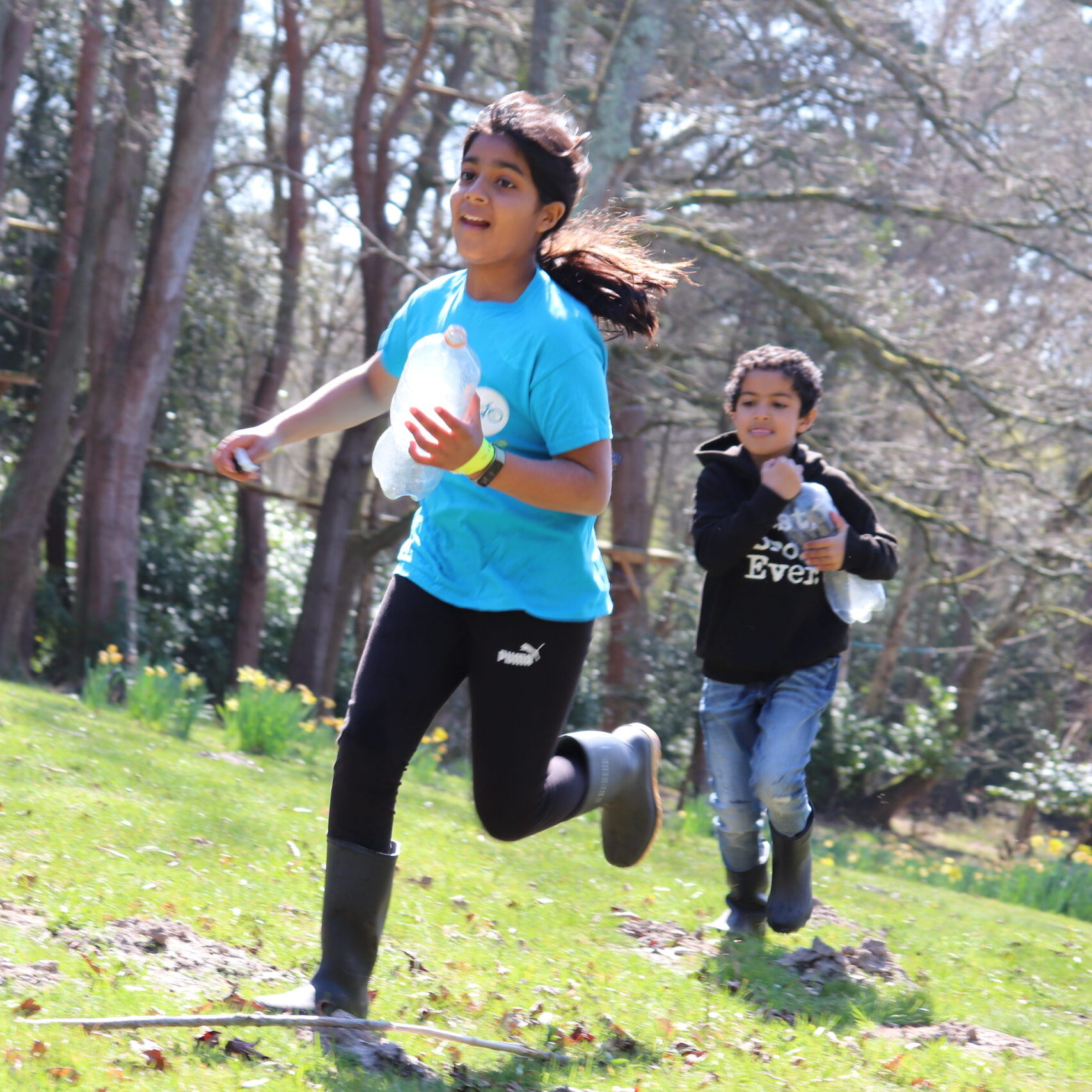 Children running in a field outdoors